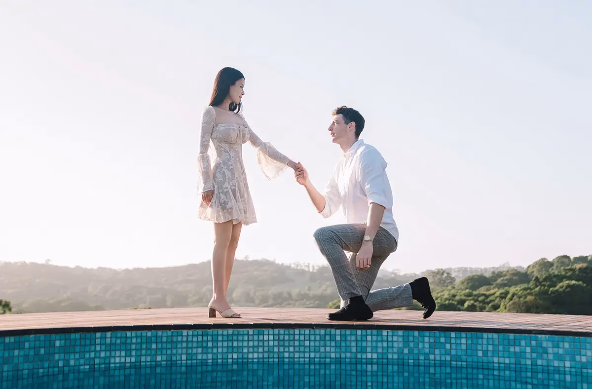 Man proposing by the pool in the sunset